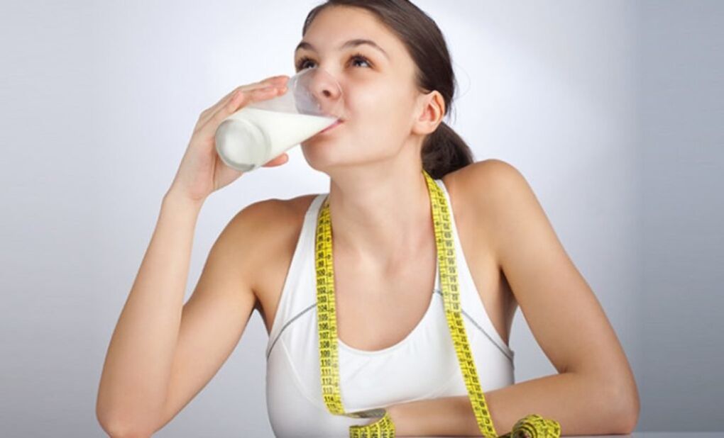 The girl drinks kefir to lose weight