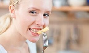 The girl is eating pasta
